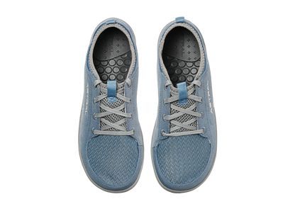 The Astral Loyak - Women's are blue textured canvas shoes with gray laces, a black patterned insole, and FlexGrip for better traction, perfect for kayaking adventures. Viewed from above.