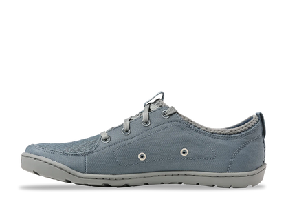 The Astral Loyak - Women's sneaker features a blue-gray canvas design with a textured FlexGrip sole, visible stitching, lace-up closure, and two decorative side eyelets, making it ideal for kayaking adventures.