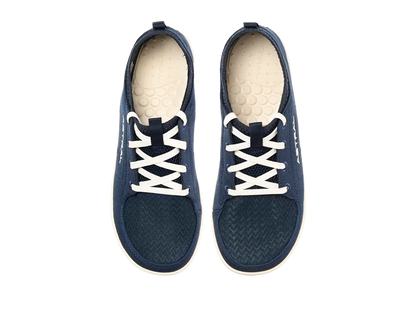 The Astral Loyak - Women's, a pair of dark blue casual shoes with FlexGrip technology, features white laces and off-white interior soles. Perfect for a relaxed day out or versatile water shoes for kayaking adventures.