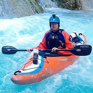 a man in an orange kayak in the water.