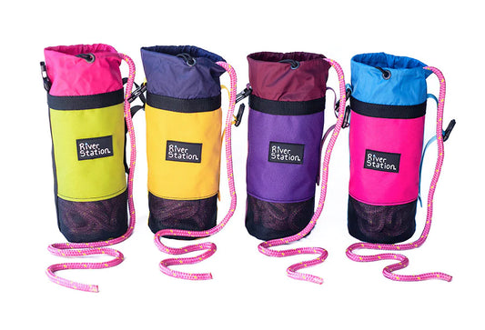Four colorful River Station Gear B.O.A.T. - Classic Rescue Throw Bags with durable materials and floating rescue ropes for water rescue lined up side by side.
