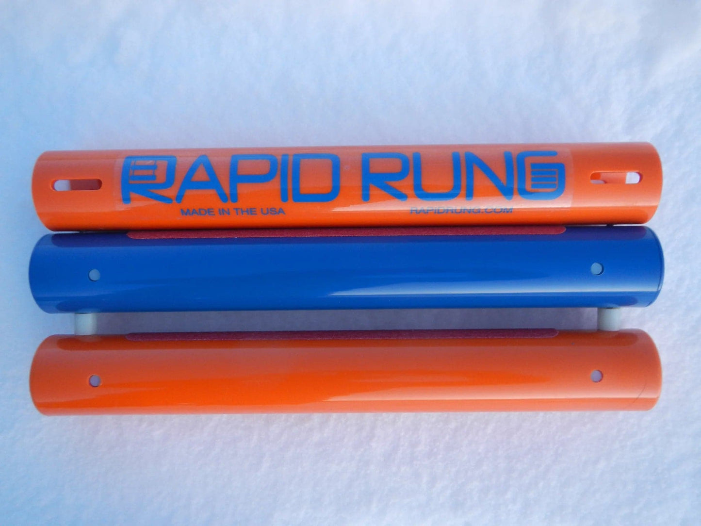 Two orange and blue tubes with the word Rapid Rung on them.