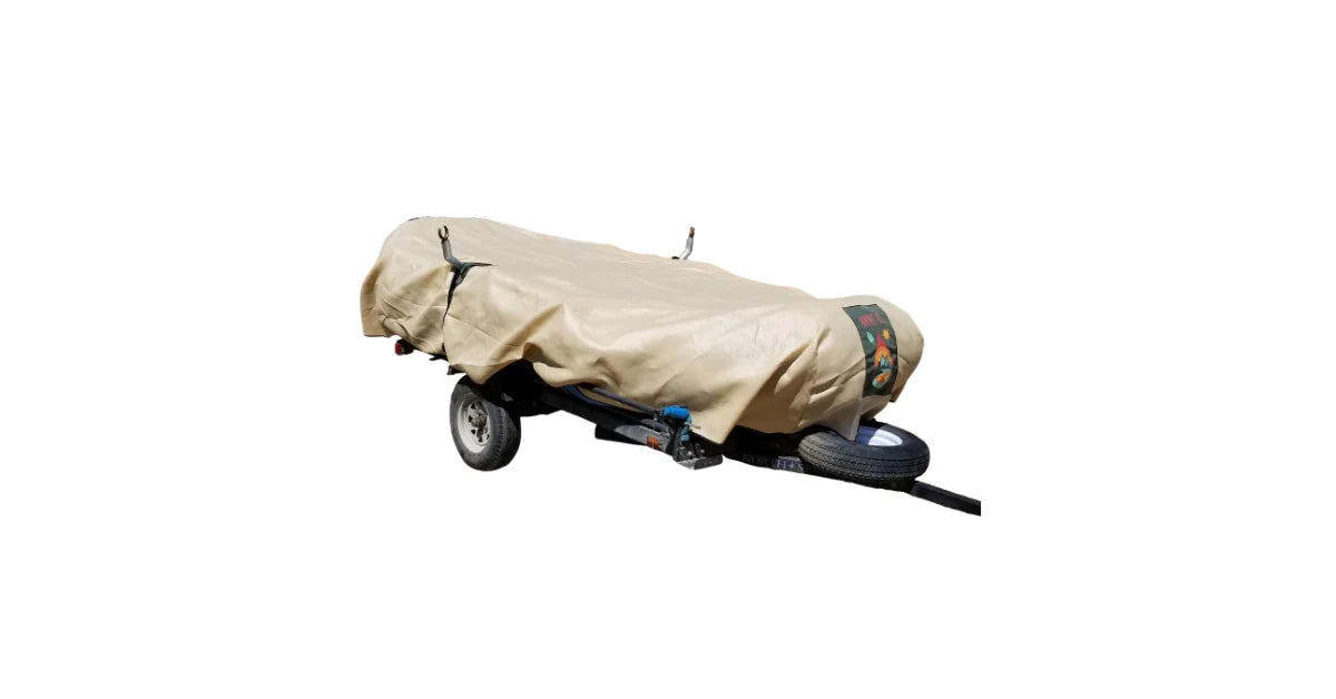 The Over It Raft Covers’ beige, UV-stabilized tarp protects your small trailer—equipped with two wheels and a front-mounted spare tire—making it ideal for safely transporting whitewater rafts.