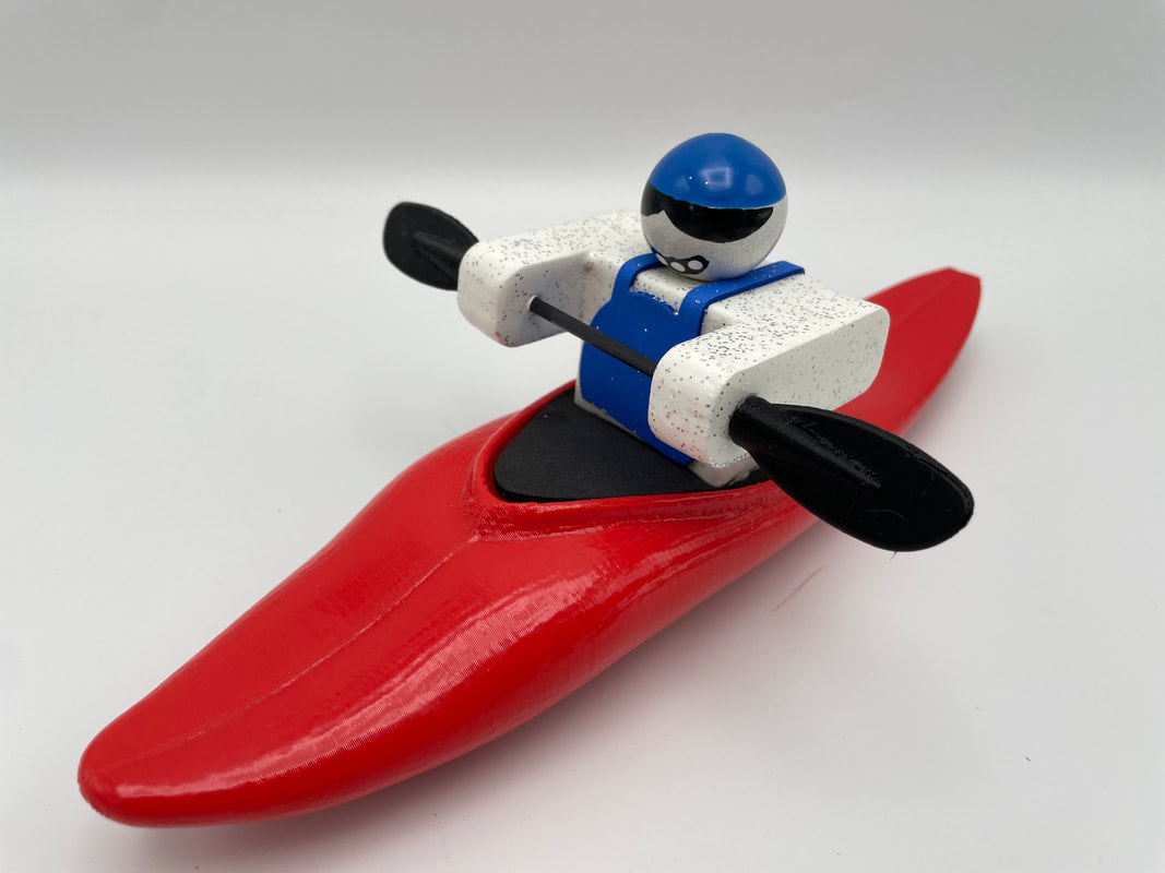 The Foamie Half-Slice features a red toy kayak with a blue and white character from the Foamie Friends series, energetically paddling with a black oar, creating dynamic motion ideal for river play against a plain background.