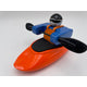 A Foamie Friends figure, part of the Foamie Spud Play Boat set, features a helmet and life vest while paddling an orange play boat with two oars, demonstrating river dynamics in action.