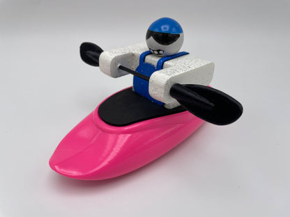 Discover the adventurous Foamie Friends toy figure, primed to conquer river dynamics in their Foamie Spud Play Boat. Equipped with a blue helmet and black paddles, this explorer is all set for thrilling journeys in a vibrant pink kayak.