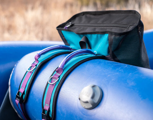 Blue inflatable raft with an attached River Station Gear Thwart Bag - Rafting Mesh Gear Bag featuring a YKK zipper.