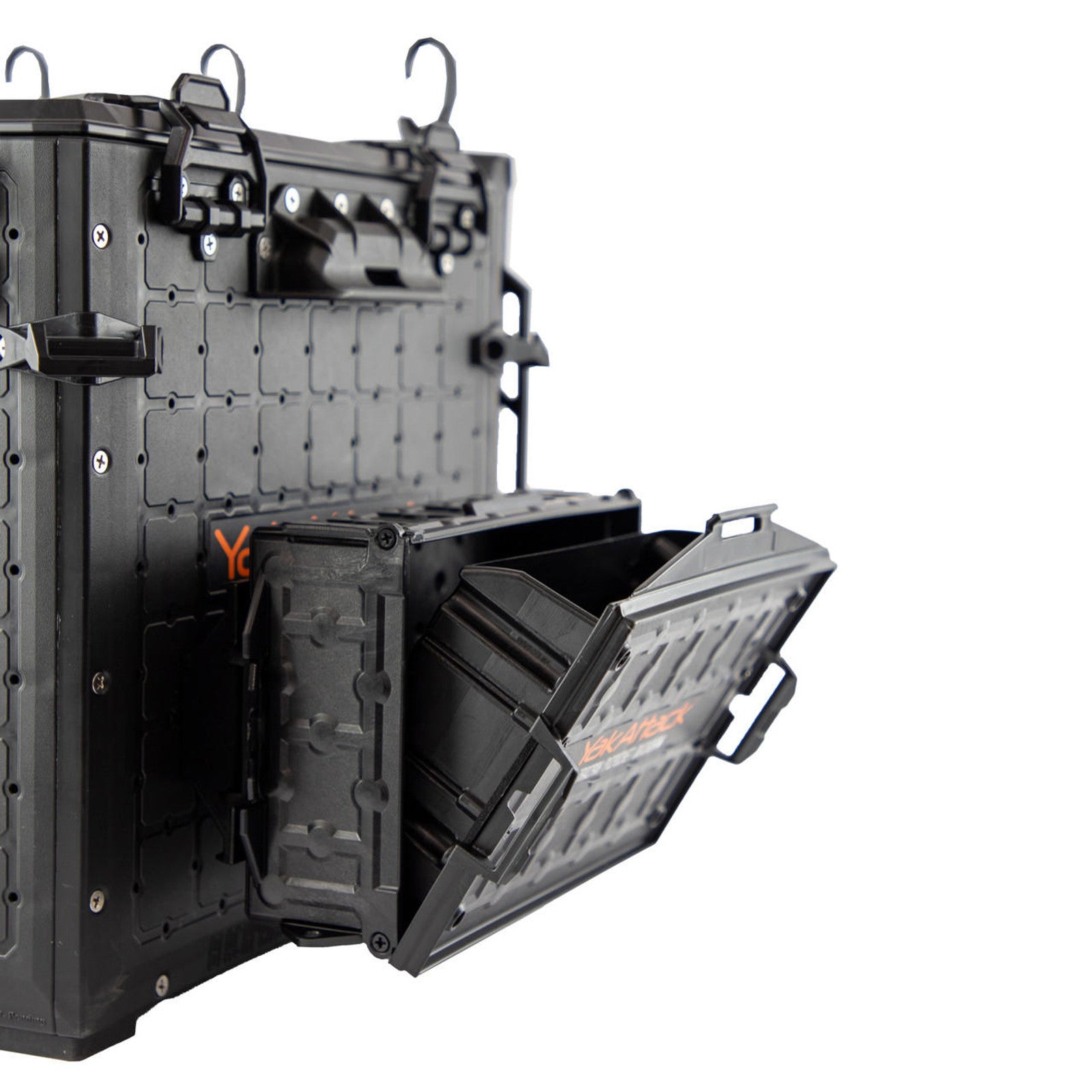 A YakAttack TracPak with PicPocket QuickDraw in black is wall-mounted, shown with its box open to reveal the hinged lid and interior compartment.