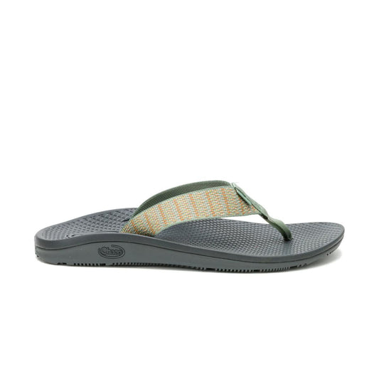 A Chaco CLASSIC FLIP - WOMEN'S sandal is shown from the side on a white background, featuring a textured dark gray sole, green and beige woven strap, and supportive LUVSEAT footbed.