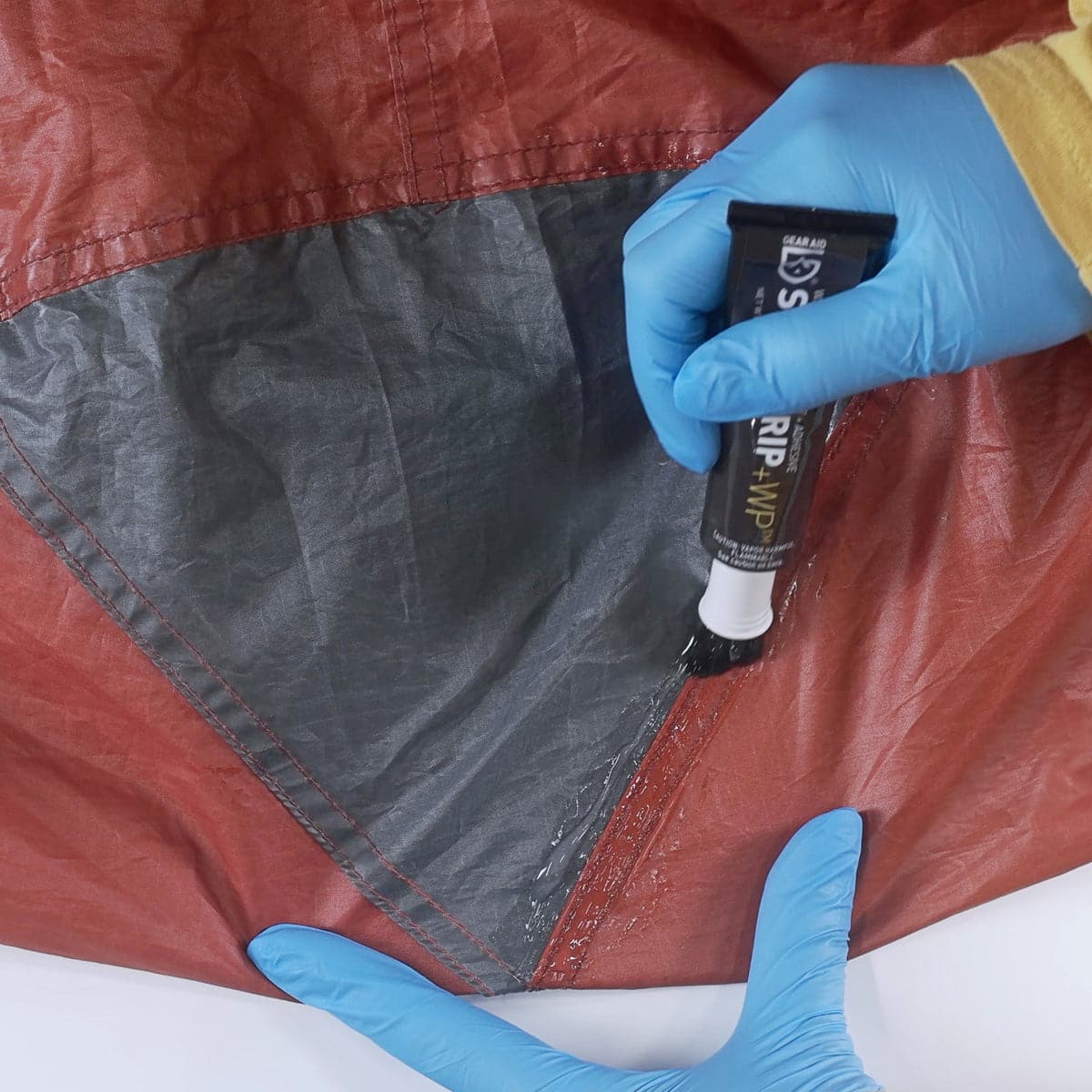 Featuring the Seam Grip+WP 1oz adhesive, glue, river wing repair, seam repair, sup care, sup repair, tent repair manufactured by Gear Aid shown here from a third angle.