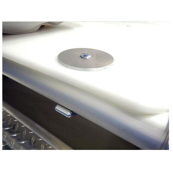 A round metal disc with a center screw rests on a white surface, showcasing CNC precision. Below, a textured metallic box with a handle evokes the sturdy resilience of Down River Equipment's DRE Poly Deck Hinge.