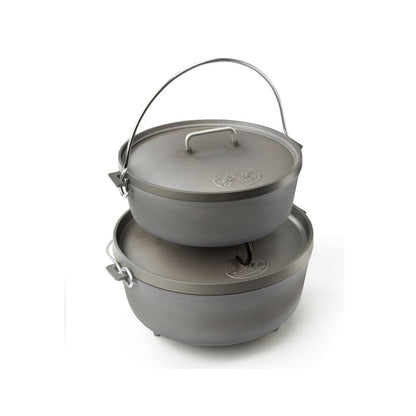 Two stacked gray cast iron Dutch ovens with lids and metal handles, designed by GSI Outdoors, feature a lightweight design similar to the 12-inch Dutch Oven.