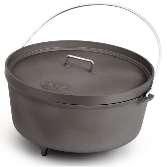 The GSI Outdoors Dutch Oven - 12in is a black, lightweight cookware piece featuring a metal handle and three legs for versatile cooking.