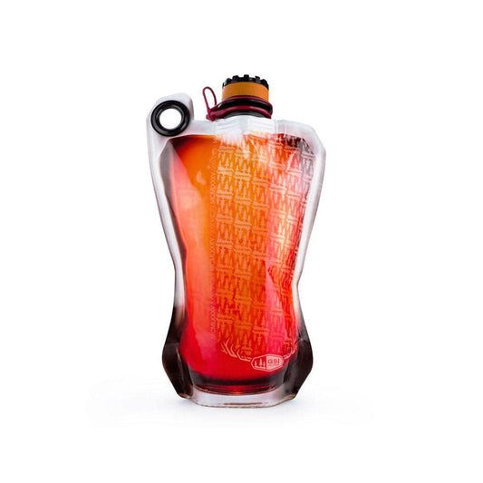 The GSI Outdoors Soft Flask 750ml is a collapsible, BPA-free transparent bottle filled with red liquid. It features a black cap and an orange, patterned internal layer. Its lightweight design makes it perfect for on-the-go adventures.