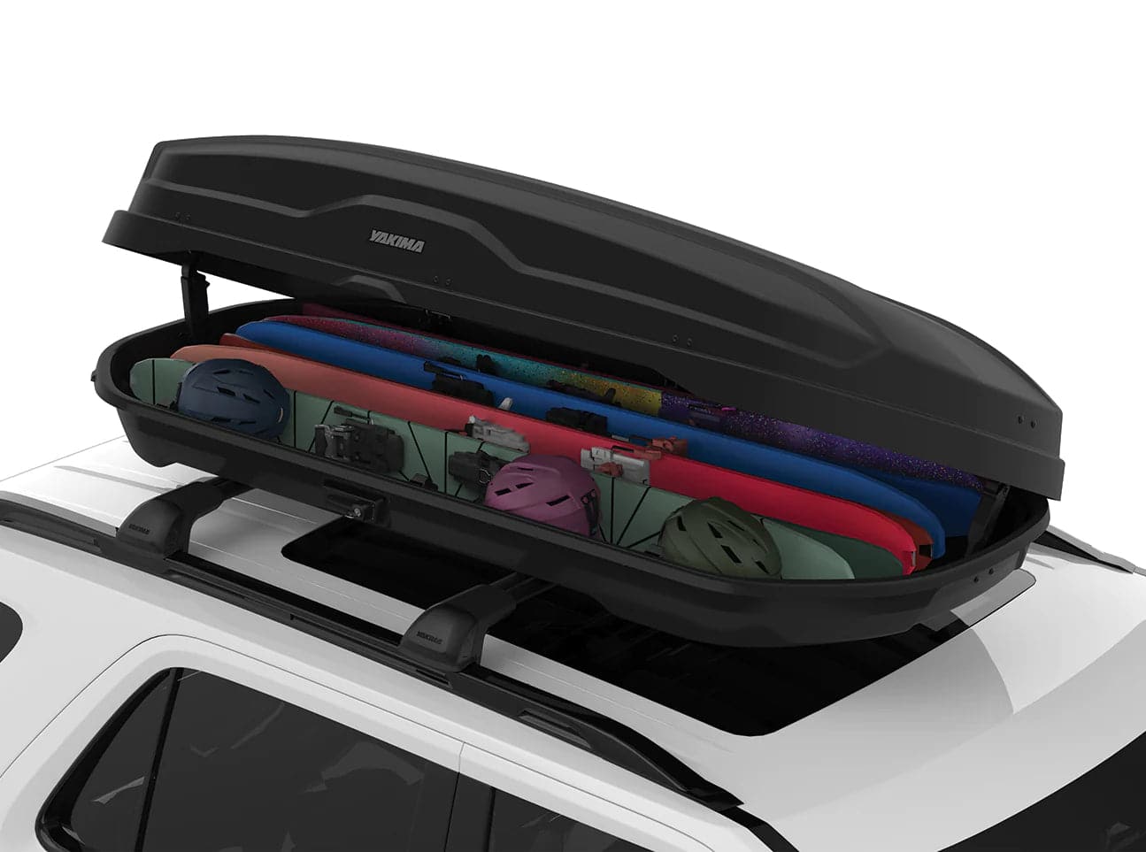 The Yakima Skybox NX XL is open, showing surfboards, helmets, snorkeling gear, and more. This cargo box features a nano-texture to keep your adventures organized and protected from the elements.
