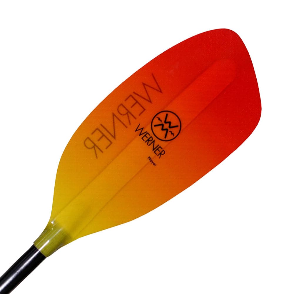 Close-up of a whitewater kayak paddle blade with a striking red to yellow gradient, designed for a powerful catch. The paddle shows the "Werner Paddles" brand name and logo, and is called the "Player.