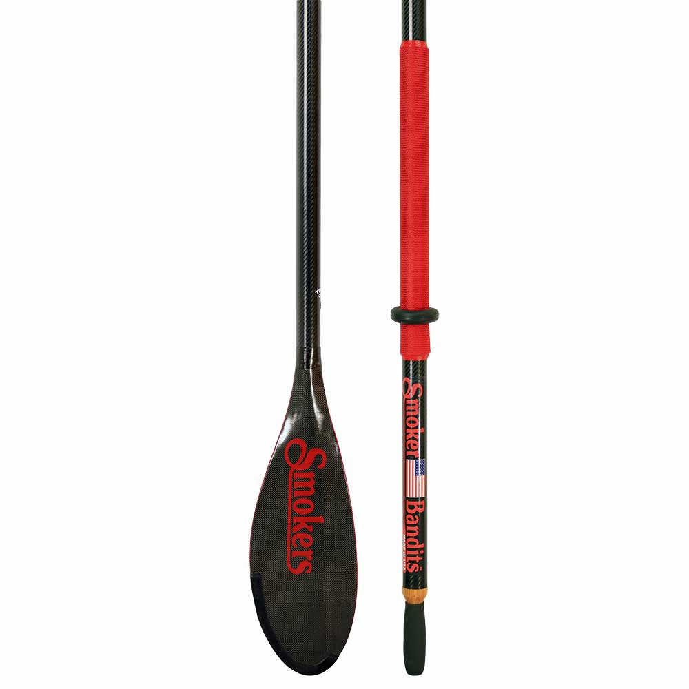 Close-up of a Sawyer Smoker Bandit Oar showcasing a sleek carbon fiber blade with "Smokers" in red text, complemented by a red handle featuring the word "Bandits" alongside an American flag design.