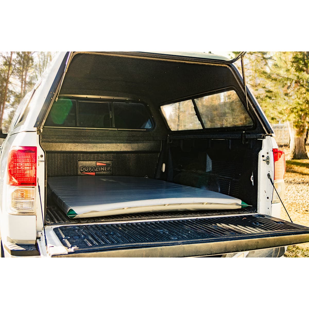 Featuring the Truckbed Landing Pad sleep pad manufactured by AIRE shown here from a fourth angle.
