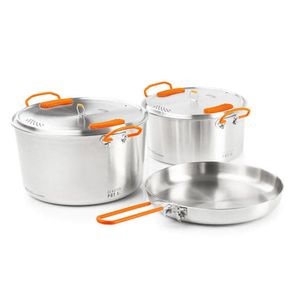 Introducing the Glacier Base Camper set by GSI Outdoors: three stainless steel pots with vibrant orange handles for gourmet cooking. This set includes a large pot, medium pot, and versatile frying pan, perfect for culinary adventures.