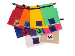 Jacks Plastic Welding's Kayak Stow bags are colorful drawstring bags crafted from durable PVC-coated polyester in red, orange, yellow, green, blue, pink, purple, white, and beige. Each features a square logo badge and doubles as a versatile dry bag.