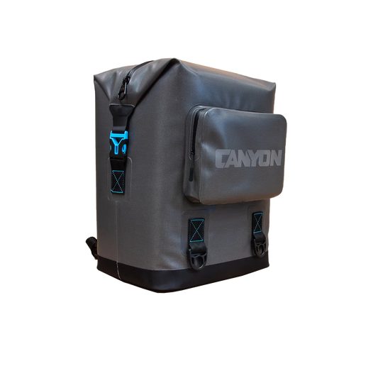 Gray rectangular "Nomad Go Soft Cooler Backpack" by Canyon Coolers features a front zip pocket, blue accents, and "Canyon" printed on the front. Its leak-proof design ensures both style and functionality for your adventures.
