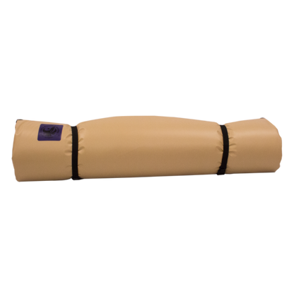 The Pickup Paco Pad by Jacks Plastic Welding, a beige, self-inflating sleeping bag, is neatly rolled and secured with two black straps against a white background.